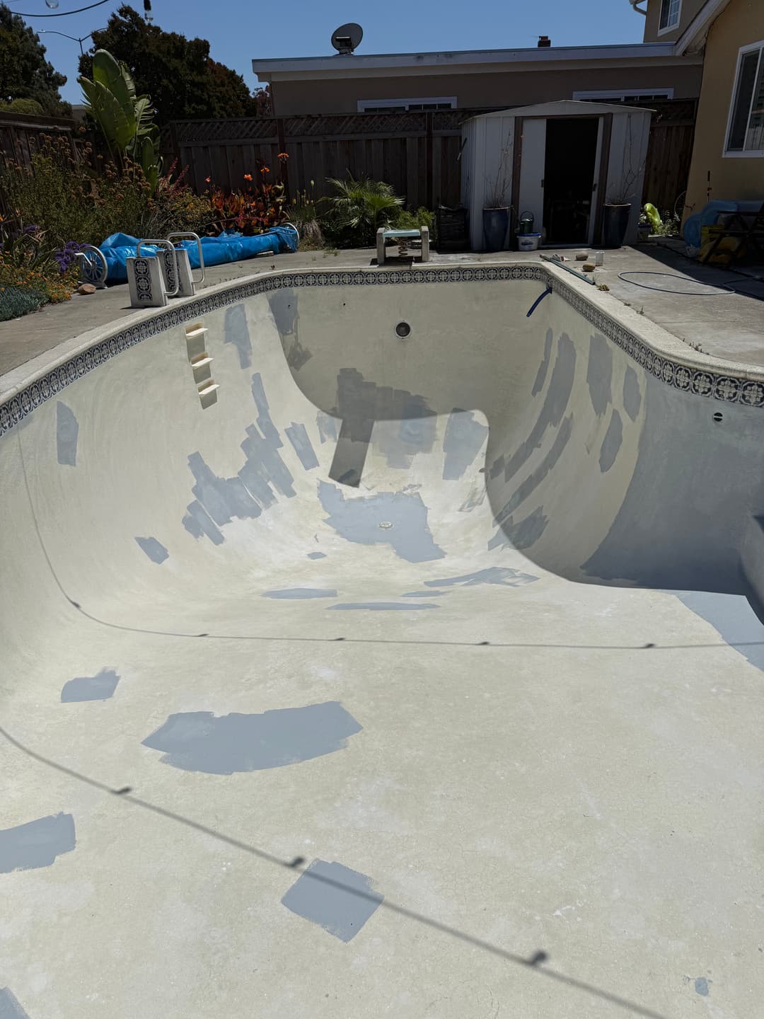 Pool interior before cleaning showing buildup prior to service