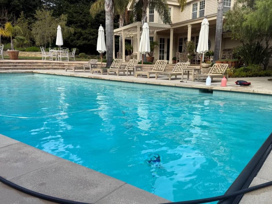 Large backyard pool cleaned and serviced for weekly pool maintenance